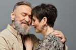 Loving seniors enjoy a tender embrace, capturing their deep connection and affection. Visual for an estate planning blog discussing five essential things your spouse needs to know before you pass away.