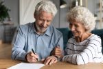 elderly couple working on a document
